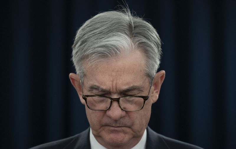 US Federal Reserve Bank Chairman Jerome Powell looks at his notes during a press conference in Washington, DC, on December 11, 2019. - Powell said Wednesday he would want to see a "significant" and "persistent" inflation rise before he would raise rates to clamp down on prices. For now, the Fed's benchmark interest rate "is appropriate and will remain appropriate" until there is a change in the outlook, he said. "In order to move rates up, I would want to see inflation that is persistent and that is significant," Powell told reporters. (Photo by Eric BARADAT / AFP)