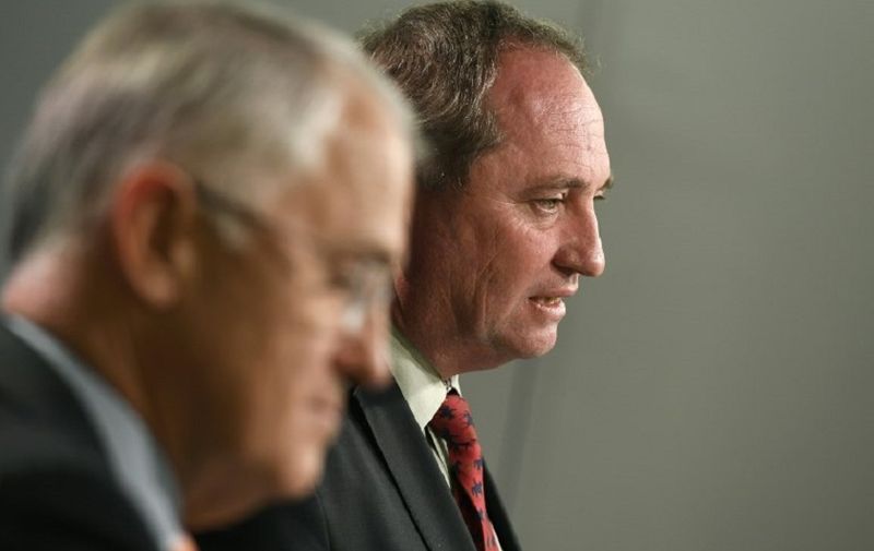 Australia's Deputy Prime Minister Barnaby Joyce (R) addresses a press conference in Sydney on July 5, 2016 as Prime Minister Malcolm Turnbull (L) listens.
Three days after polls closed the result is still too close to call, with Prime Minister Malcolm Turnbull's Liberal/National coalition and the opposition Labor party each short of the 76 seats needed to govern, raising the prospect of a hung parliament.  / AFP PHOTO / WILLIAM WEST