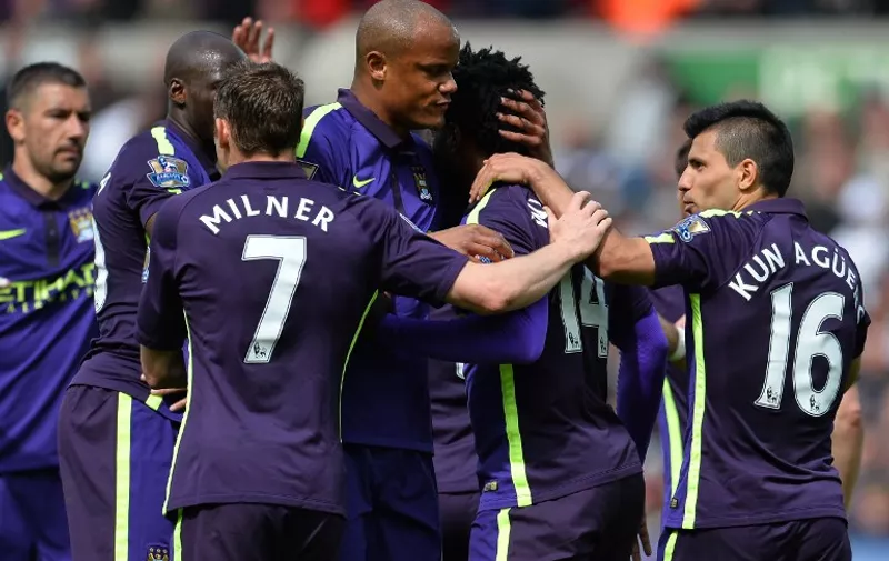 Manchester City's Ivorian striker Wilfried Bony (2R) celebrates scoring their fourth goal with his team-mates during the English Premier League football match between Swansea City and Manchester City at The Liberty Stadium in Swansea, south Wales on May 17, 2015. AFP PHOTO / GLYN KIRK

RESTRICTED TO EDITORIAL USE. No use with unauthorized audio, video, data, fixture lists, club/league logos or live services. Online in-match use limited to 45 images, no video emulation. No use in betting, games or single club/league/player publications.