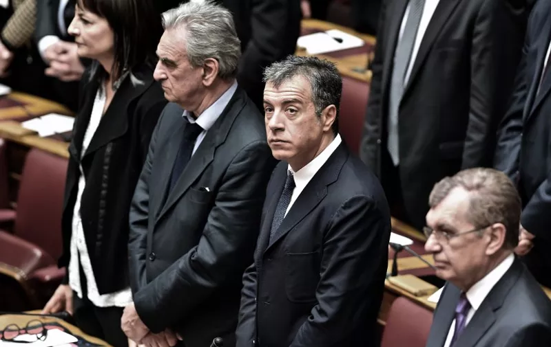 Leader of the pro-European party "To Potami" Stavros Theodorakis (C) attends a swearing in ceremony of the new parliament in Athens on February 5, 2015. Greece's parliament met for the first time after last month's election amid market jitters sparked by an ECB block on a key source of funding for Athens' banks. AFP PHOTO / ARIS MESSINIS