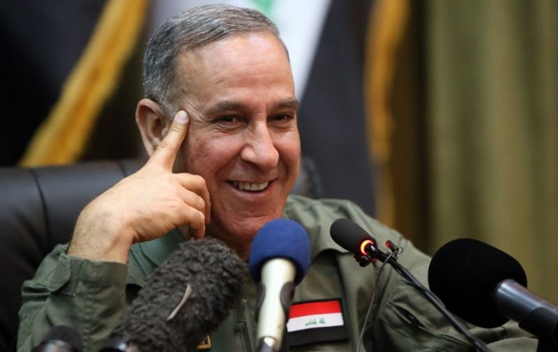 Iraqi Defence Minister Khaled al-Obeidi smiles during a press briefing with members of the foreign media on March 18, 2015, in Baghdad. Iraq's offensive to retake Tikrit from the Islamic State group was stalled this week because of streets and buildings rigged with booby trap bombs and by the several hundred jihadists still holding out there as well as to avoid casualties and to protect infrastructure, Iraqi officials have said.    / 