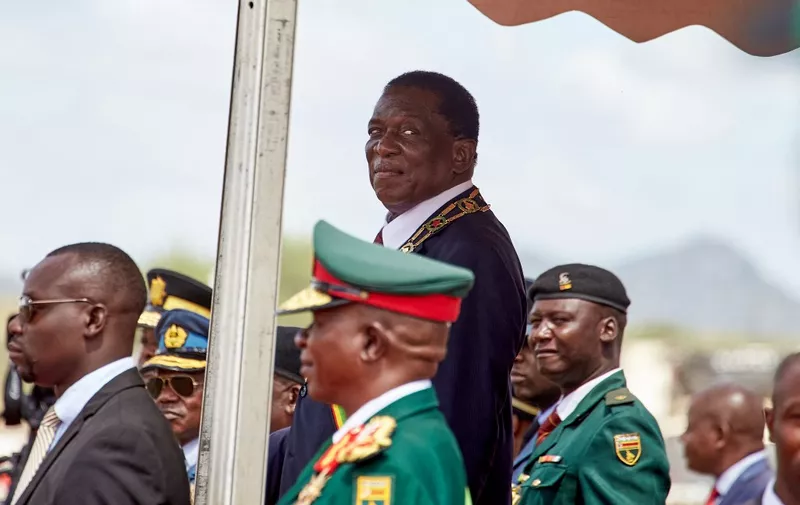 Zimbabwe President Emmerson Mnangagwa looks on as he inspects the guard of honor at the country's 43rd Independence Day celebrations held in Mount Darwin, Mashonaland Central province, on April 18 2023. Zimbabwean President Emmerson Mnangagwa on Tuesday vowed that general elections expected later this year will be free and fair as he warned "rogue" civic society organisations during an independence day speech. The southern African country is due to hold presidential and legislative votes, expected to be in August, but no date has been announced yet. (Photo by Jekesai NJIKIZANA / AFP)