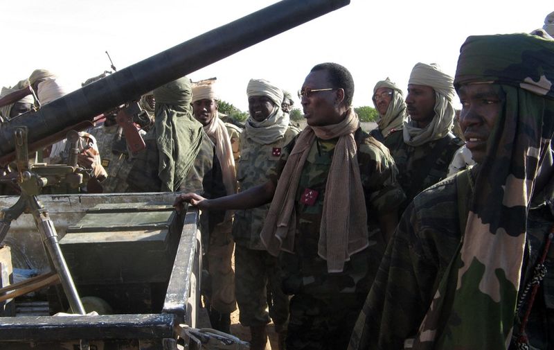 (FILES) In this file photo taken on December 14, 2006 Chadian President Idriss Deby (C) inspects a seized rebel technical in Adre, Chad. After days of fierce fighting, Chad's army and rebels hostile to President Idriss Deby Itno made preparations on opposite sides of the Sudanese border for the next battle. - Chadian President Idriss Déby Itno, who has been in power for 30 years, died on April 20, 2021 from injuries sustained while commanding his army in fighting against rebels in the north over the weekend, a spokesman announced on state television. (Photo by SONIA ROLLEY / AFP)