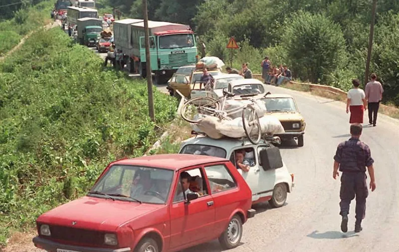 A convoy of Croatian Serb refugees from Knin wait to cross the Bosnian-Rump-Yugoslav border near the eastern Bosnian town of Raca, approximately 130 km (80 miles) west of Belgrade, 06 August. International relief agencies are bracing for a massive exodus of Serb refugees fleeing the Croatian offensive in breakaway Krajina and are beginning to organize food airlifts in order to avoid a humanitarian disaster.   AFP PHOTO