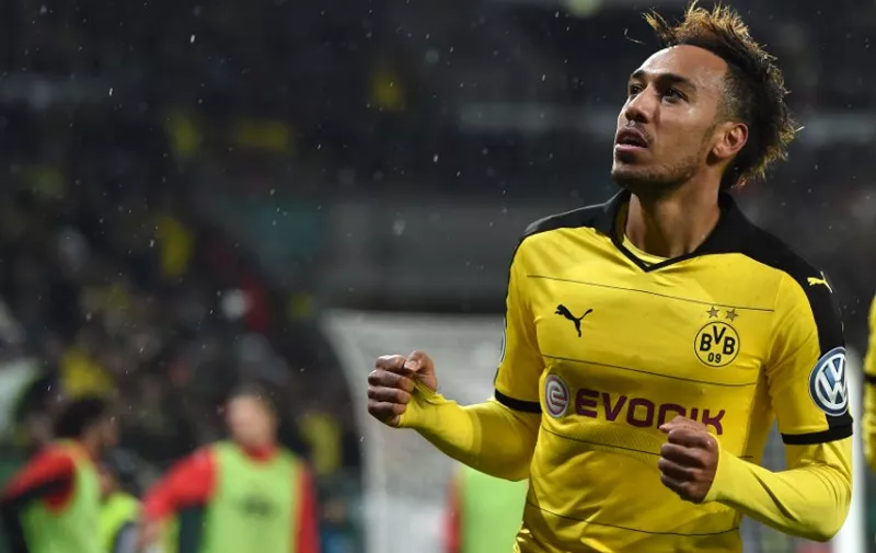 Dortmund's Gabonese striker Pierre-Emerick Aubameyang celebrates after his goal during the German Cup DFB Pokal third round match between Borussia Dortmund and FC Augsburg in Augsburg on December 16, 2015.  / AFP / Christof STACHE / RESTRICTIONS: ACCORDING TO DFB RULES IMAGE SEQUENCES TO SIMULATE VIDEO IS NOT ALLOWED DURING MATCH TIME. MOBILE (MMS) USE IS NOT ALLOWED DURING AND FOR FURTHER TWO HOURS AFTER THE MATCH. == RESTRICTED TO EDITORIAL USE == FOR MORE INFORMATION CONTACT DFB DIRECTLY AT +49 69 67880

 /