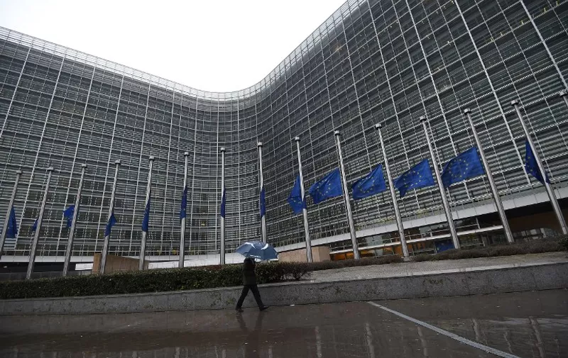 European Union flags fly half-mast at the European Parliament in Brussels on January 8, 2015, following an attack on January 7 against French satirical weekly newspaper Charlie Hebdo which left 12 people dead. A stunned and outraged France began a national day of mourning on January 8, as security forces desperately hunted two brothers suspected of gunning down 12 people in an Islamist assault on a satirical weekly, the country's bloodiest attack in half a century. AFP PHOTO / EMMANUEL DUNAND / AFP PHOTO / EMMANUEL DUNAND