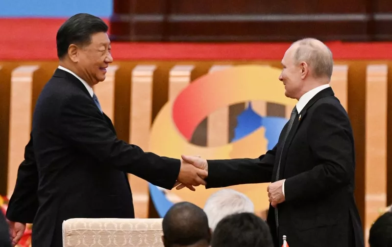 China's President Xi Jinping (L) shakes hands with Russia's President Vladimir Putin during the opening ceremony of the third Belt and Road Forum for International Cooperation at the Great Hall of the People in Beijing on October 18, 2023. (Photo by Pedro PARDO / AFP)