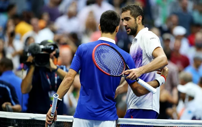 NEW YORK, NY - SEPTEMBER 11: Novak Djokovic (L) of Serbia embraces Marin Cilic of Croatia after defeating him during their Men's Singles Semifinals match on Day Twelve of the 2015 US Open at the USTA Billie Jean King National Tennis Center on September 11, 2015 in the Flushing neighborhood of the Queens borough of New York City. Djokovic defeated Cilic 6-0, 6-1, 6-2.   Matthew Stockman/Getty Images/AFP