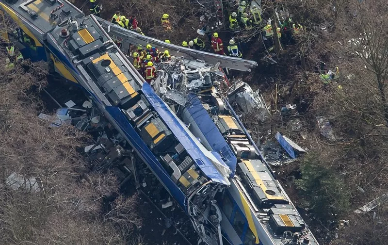 Aerial view shows firefighters and emergency doctors working at the site of a train accident near Bad Aibling, southern Germany, on February 9, 2016.
Two Meridian commuter trains operated by Transdev collided head-on near Bad Aibling, around 60 kilometres (40 miles) southeast of Munich, killing at least eight people and injuring around 100, police said. The cause of the accident was not immediately clear. / AFP / dpa / Peter Kneffel / Germany OUT