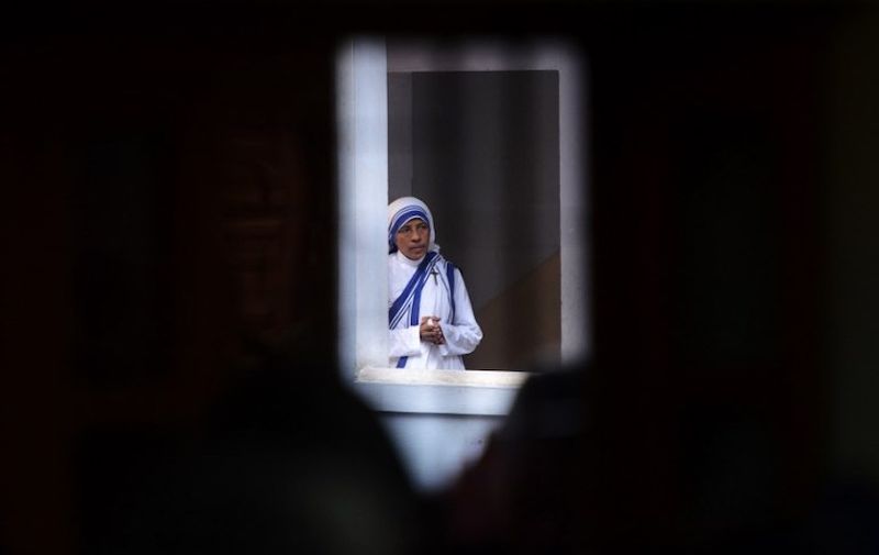 A Roman Catholic nun of the Missionaries of Charity order prays near the tomb of Mother Teresa at a service to commemorate the 20th death anniversary of Mother Teresa at the Missionaries of Charity house in Kolkata on September 5, 2017
Pope Francis on September 4, 2016 proclaimed Mother Teresa a saint, hailing her work with the destitute of Kolkata as a beacon for mankind and testimony of God's compassion for the poor. The revered nun's elevation to Roman Catholicism's celestial pantheon came in a canonisation mass in St Peter's square presided over by Pope Francis. / AFP PHOTO / Dibyangshu SARKAR