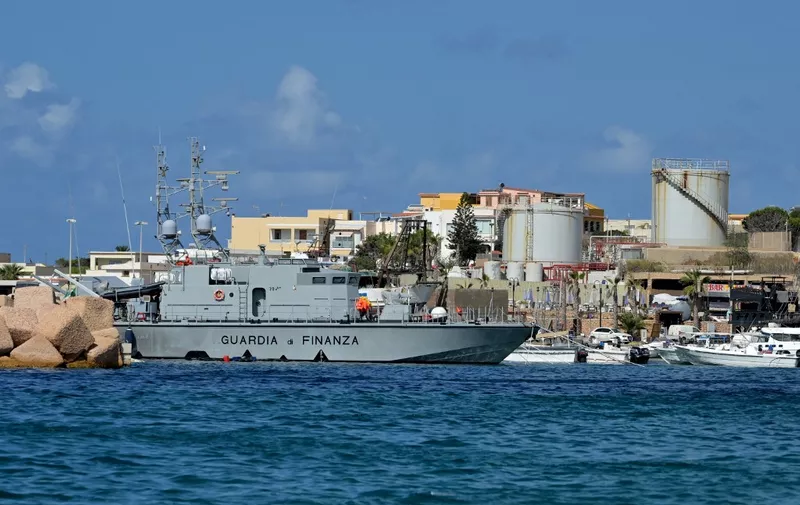 A ship of the Italian 'Guarda di Finanza' is moored in the port of the small island of Lampedusa, south of Sicily, on september 25, 2023. (Photo by Tiziana FABI / AFP)