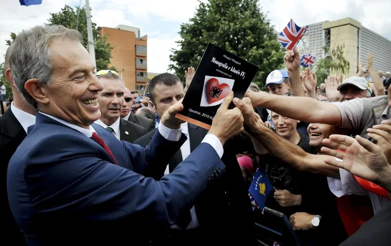 Former British Prime Minister Tony Blair (L) greets Kosovar Albanians gathering in Pristina on July 9, 2010.  Former British Prime Minister Tony Blair was welcomed as a hero during his two day visit in Kosovo as he met several children who were even named after him in the newly declared state.  AFP PHOTO/ARMEND NIMANI (Photo by ARMEND NIMANI / AFP)