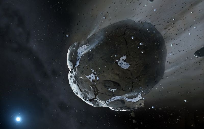 This is an artist impression obtained from The University of Warwick and The University of Cambridge shows a rocky and water-rich asteroid being torn apart by the strong gravity of the white dwarf star GD 61. Similar objects in the Solar System likely delivered the bulk of water on Earth and represent the building blocks of the terrestrial planets. Astrophysicists have found the first evidence of a water-rich rocky planetary body outside our solar system in its shattered remains orbiting a white dwarf. in a new study released October 10, 2013, scientists at the Universities of Warwick and Cambridge published in the journal Science analysed the dust and debris surrounding the white dwarf star GD61, 170 light years away. Using observations obtained with the Hubble Space Telescope and the large Keck telescope on Hawaii, they found an excess of oxygen  a chemical signature that indicates that the debris had once been part of a bigger body originally composed of 26 per cent water by mass. By contrast, only approximately 0.023 per cent of the Earth's mass is water. = RESTRICTED TO EDITORIAL USE - MANDATORY CREDIT "AFP PHOTO /  Image copyright Mark A. Garlick, space-art.co.uk, The University of Warwick and The University of Cambridge" - NO MARKETING NO ADVERTISING CAMPAIGNS - DISTRIBUTED AS A SERVICE TO CLIENTS  NO ARCHIVE =     Embargoed for release: 10-Oct-2013 14:00 ET (18:00 GMT)