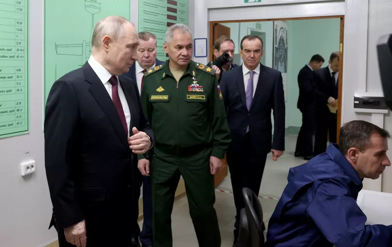 In this pool photograph distributed by the Russian state owned agency, Russian President Vladimir Putin (L) and Russia's Defence Minister Sergei Shoigu (C) visit the Krasnodar Higher Military Aviation School of Pilots in Krasnodar on March 7, 2024. (Photo by Vladimir GERDO / POOL / AFP)