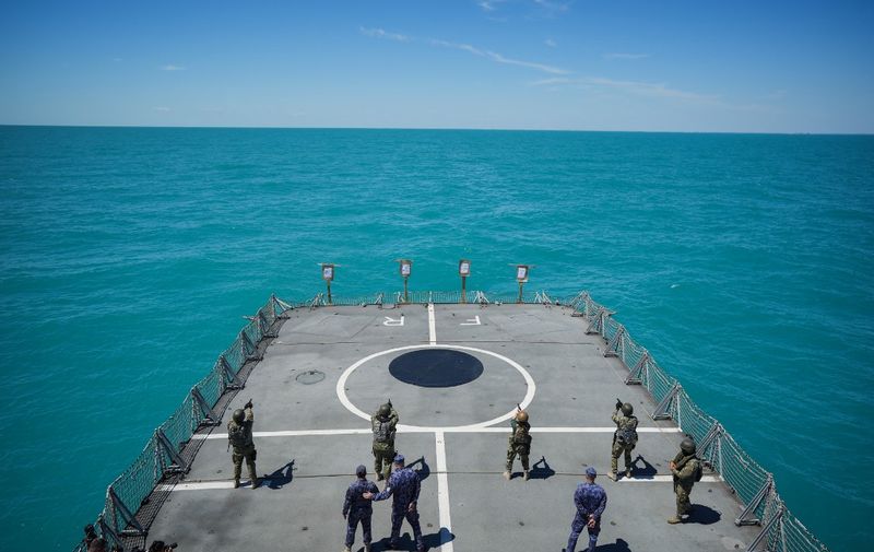 Romanian navy special forces take part in a shooting drill on the "King Ferdinand" frigate during the "Shield Protector" military exercise on the Black Sea, near Constanta, Romania, on June 22, 2022. Around 800 soldiers take part in the annual "Shield Protector" operation, a two-day drill organized by the Romanian Naval Forces, meant to consolidate the NATO combat procedures among the navy military. (Photo by MIHAI BARBU / AFP)