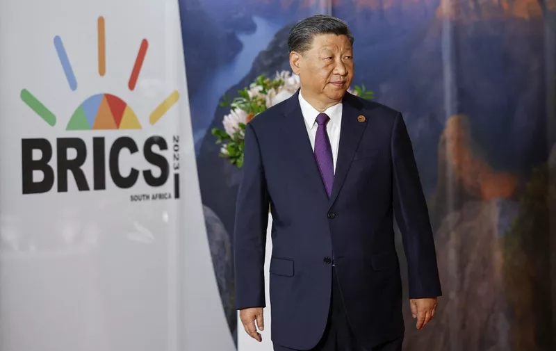 President of China Xi Jinping arrives at the 2023 BRICS Summit at the Sandton Convention Centre in Johannesburg on August 23, 2023. (Photo by GIANLUIGI GUERCIA / POOL / AFP)