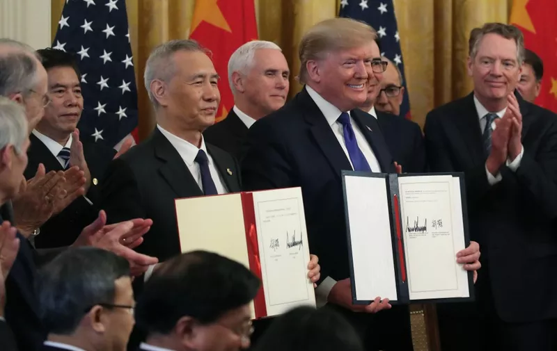 WASHINGTON, DC - JANUARY 15: U.S. President Donald Trump and Chinese Vice Premier Liu He, hold up signed agreements of phase 1 of a trade deal between the U.S. and China, in the East Room at the White House, on January 15, 2020 in Washington, DC. Phase 1 is expected to cut tariffs and promote Chinese purchases of U.S. farm, and manufactured goods while addressing disputes over intellectual property.   Mark Wilson/Getty Images/AFP