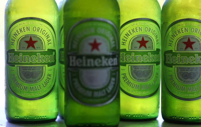 In this photo illustration, bottles of Heineken beer are displayed in San Anselmo, California on July 31, 2023. Dutch brewer Heineken on August 25, 2023, announced it was pulling out of Russia after selling its operations to the Arnest Group, the largest Russian manufacturer of cosmetics, household goods and metal packaging. (Photo by Justin SULLIVAN / GETTY IMAGES NORTH AMERICA / AFP)