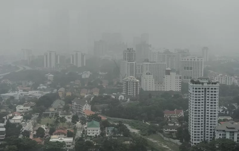 This overhead view shows residential houses and commercial buildings covered in haze in Kuala Lumpur on September 29, 2015.  Malaysia, Singapore and large expanses of Indonesia have suffered for weeks from acrid smoke billowing from fires on plantations and peatlands in Indonesia that are being illegally cleared by burning.   