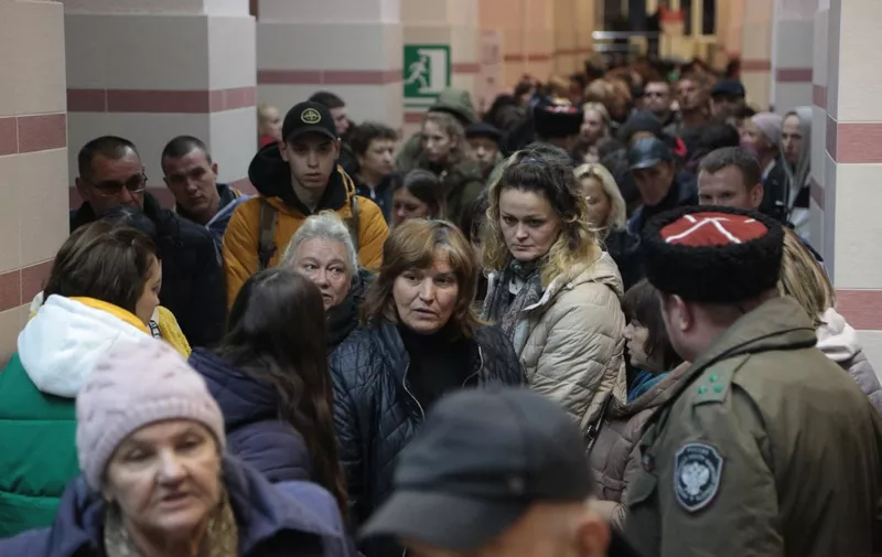 People arrived from Kherson wait for further evacuation into the depths of Russia inside the Dzhankoi's railway station in Crimea on October 21, 2022. - The Moscow-installed authorities of the southern Ukrainian Kherson region said on October 20, 2022 that around 15,000 people have been pulled from the territory that Russia claims to have annexed in the face of a Ukrainian advance. (Photo by STRINGER / AFP)