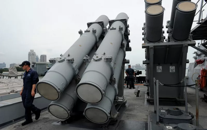 A US Navy officer walks past a set of harpoon cruise missile launchers on the deck of the USS Milius DDG69, a multi-mission capable guided missile destroyer ship docked at the Manila south harbour on August 18, 2012. The USS Milius is in Manila for a four-day goodwill visit. AFP PHOTO / NOEL CELIS (Photo by NOEL CELIS / AFP)