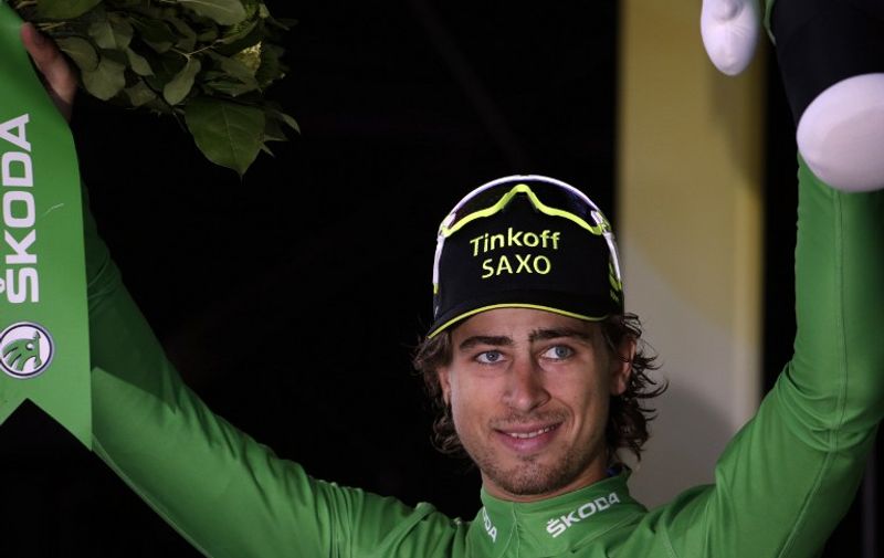 Slovakia's Peter Sagan celebrates his green jersey of best sprinter on the podium at the end of the 138 km nineteenth stage of the 102nd edition of the Tour de France cycling race on July 24, 2015, between Saint-Jean-de-Maurienne and La Toussuire, French Alps. AFP PHOTO / KENZO TRIBOUILLARD