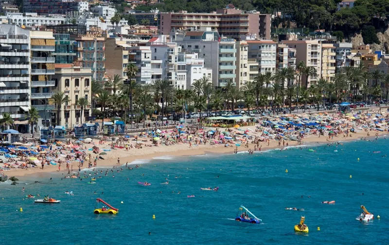 People enjoy the sea and beach in the Catalonian coastal city of Lloret de Mar, along the Mediterranean sea on August 7, 2016. (Photo by JOSEP LAGO / AFP)