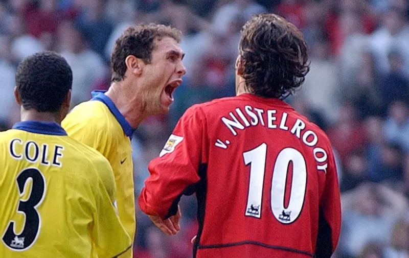 Arsenal's Martin Keown taunts Manchester United's Ruud Van Nistelrooy after he missed a penalty given away by Keown in the final minutes of todays Premiership clash at Old Trafford, Manchester 21 September 2003. AFP Photo by Paul Barker