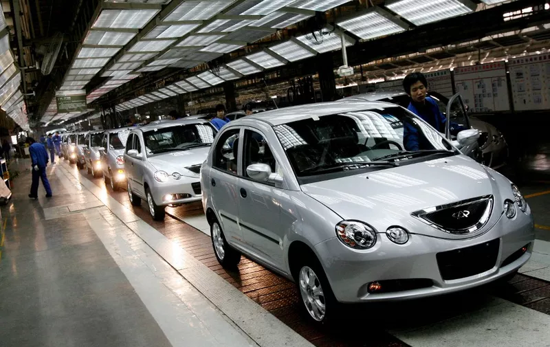 Chinese automotive workers check Chery QQ6 model cars as they come off the assembly line at their factory in Wuhu, Anhui Province, 07 December 2007.  The company may delay its planned entry into the US and European markets because of problems meeting tougher regulations. It usually takes at least 24 to 36 months of testing to meet US crash test standards, which means Chery would likely not have vehicles ready for delivery before 2011, at the very earliest.         AFP PHOTO/Mark RALSTON (Photo by MARK RALSTON / AFP)