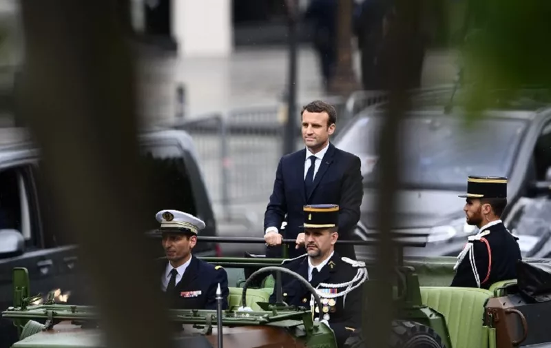 French President Emmanuel Macron parades in a car on the Champs Elysees avenue after his formal inauguration ceremony as French President on May 14, 2017 in Paris. / AFP PHOTO / Martin BUREAU