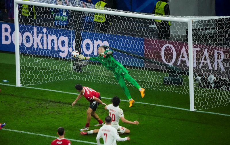 Turkey's goalkeeper Mert Gunok safes the ball during a round of sixteen match between Austria and Turkey at the Euro 2024 soccer tournament in Leipzig, Germany, Tuesday, July 2, 2024. (AP Photo/Ebrahim Noroozi)