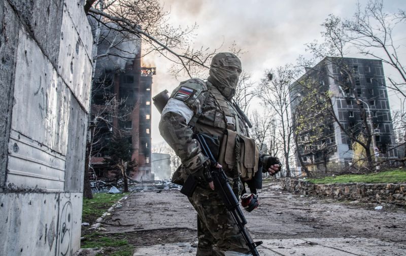 A Russian soldier stands in a Mariupol street as an apartment block burns behind him. The battle between Russian / Pro Russian forces and the defencing Ukrainian forces lead by Azov battalion continues in the port city of Mariupol.
The battle of Mariupol in Ukraine - Mar, Apr 2022,Image: 690818480, License: Rights-managed, Restrictions: , Model Release: no, Credit line: Profimedia