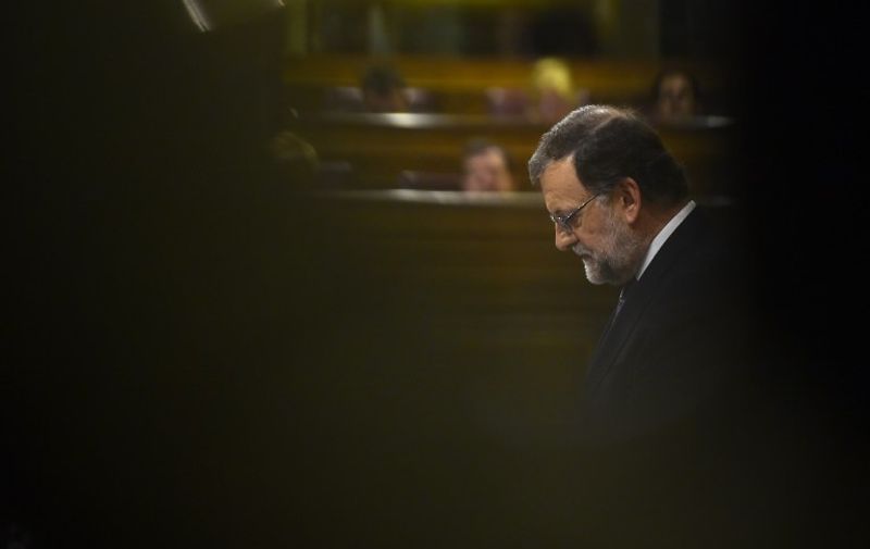 Spain's interim Prime Minister, Mariano Rajoy looks at his notes in the Spanish Congress (Las Cortes) on August 31, 2016, in Madrid during the second day of a parliamentary investiture debate to vote through a prime minister and allow the country to finally get a government.
Spain's caretaker Prime Minister Mariano Rajoy on Tuesday urged lawmakers to back him for a second term, arguing ahead of a confidence vote which he appears set to lose that the country "urgently" needs a government.


 / AFP PHOTO / PIERRE-PHILIPPE MARCOU