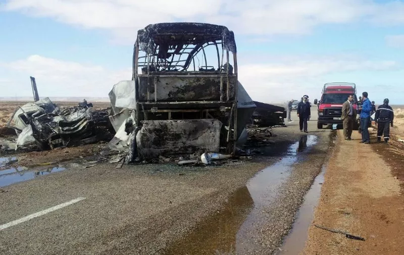 A general view shows officials standing next to the remains of a burnt out bus that caught on fire following a head-on collision with a truck as it was returning from a schoolchildren sports competition in the western Moroccan city of Tan-Tan, killing 31 people on April 10, 2015. The accident in southern Morocco is [&hellip;]