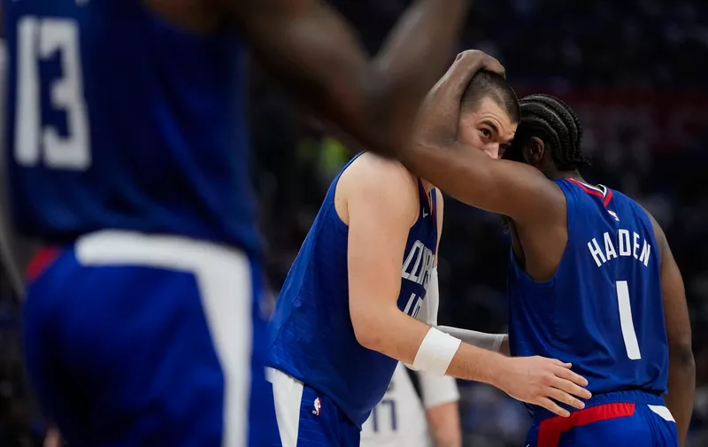 LA Clippers guard James Harden (1) and center Ivica Zubac, center, celebrate after a point during the first half of Game 1 of an NBA basketball first-round playoff series against the Dallas Mavericks in Los Angeles, Sunday, April 21, 2024. (AP Photo/Ashley Landis)