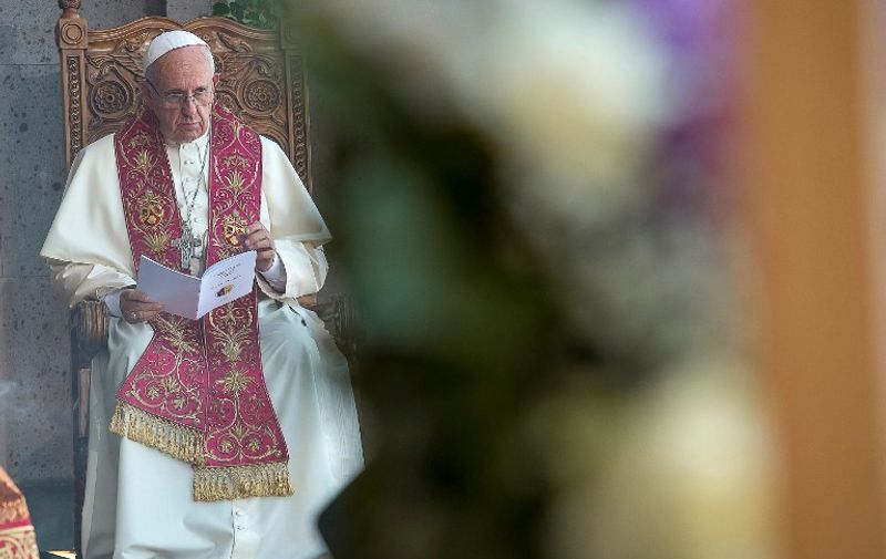 This handout picture released by the Vatican press office shows Pope Francis (C) during the Divine Liturgy at the Apostolic Cathedral in Etchmiadzin, outside Yerevan, on June 26, 2016.  / AFP PHOTO / OSSERVATORE ROMANO / HO / RESTRICTED TO EDITORIAL USE - MANDATORY CREDIT "AFP PHOTO / OSSERVATORE ROMANO" - NO MARKETING NO ADVERTISING CAMPAIGNS - DISTRIBUTED AS A SERVICE TO CLIENTS