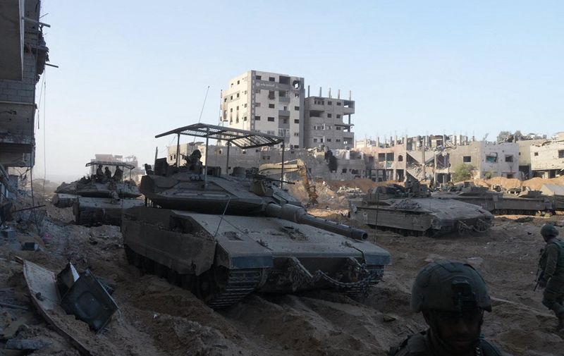 --PHOTO TAKEN DURING A CONTROLLED TOUR AND SUBSEQUENTLY EDITED UNDER THE SUPERVISION OF THE ISRAELI MILITARY
Israeli troops are pictured during operations in northern Gaza on November 8, 2023, amid continuing battles between Israel and the Palestinian militant group Hamas. (Photo by Daphné LEMELIN / AFP)