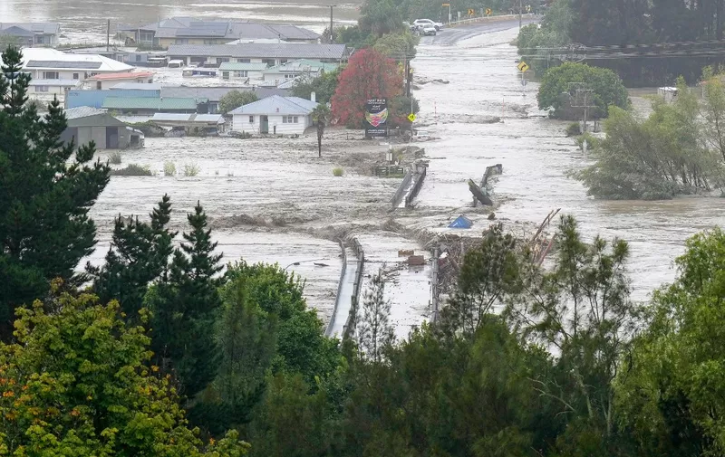 An aerial photo taken on February 14, 2023 shows the Waiohiki bridge and surrounds inundated by the Tutaekuri River after Cyclone Gabrielle made landfall near the city of Napier. - New Zealand declared a national state of emergency on February 14 as Cyclone Gabrielle swept away roads, inundated homes and left more than 100,000 people without power. (Photo by AFP) / New Zealand OUT