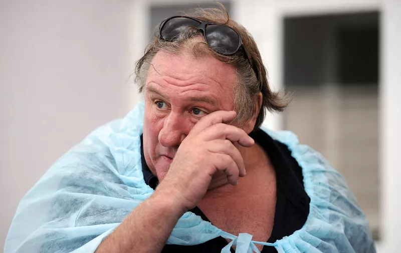 French actor Gerard Depardieu reacts as he visits a livestock farm in the village of Zadomlya, some 40 km east of Minsk, on July 22, 2015. AFP PHOTO / SERGEI GAPON (Photo by SERGEI GAPON / AFP)