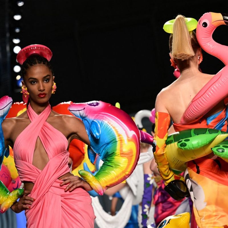 Models present creations for Moschino's Women's Spring Summer 2023 fashion collection on September 22, 2022 in Milan. (Photo by MIGUEL MEDINA / AFP)