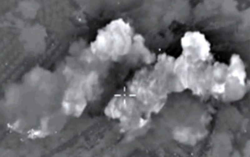 A video grab made on October 13, 2015, shows an image taken from a footage made available on the Russian Defence Ministry's official website, purporting to show explosions after airstrikes carried out by Russian air force on what Russia says was an Islamic State ammunition depot in the Syrian province of Hama. Russia's air force hit 86 "terrorist" targets in Syria in the past 24 hours, the defence ministry said on October 13, in the highest one-day tally since it launched its bombing campaign on September 30. AFP PHOTO / RUSSIAN DEFENCE MINISTRY 
*RESTRICTED TO EDITORIAL USE - MANDATORY CREDIT " AFP PHOTO / RUSSIAN DEFENCE MINISTRY" - NO MARKETING NO ADVERTISING CAMPAIGNS - DISTRIBUTED AS A SERVICE TO CLIENTS* / AFP / RUSSIAN DEFENCE MINISTRY / HO