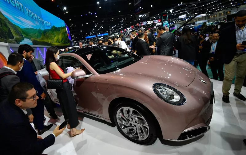 People look at the ORA Grand Cat electric vehicle (EV) during the Thailand International Motor Expo 2022 at Impact Challenger Muang Thong Thani on November 30, 2022, in Nonthaburi, Thailand. (Photo by Vachira Vachira/NurPhoto) (Photo by Vachira Vachira / NurPhoto / NurPhoto via AFP)