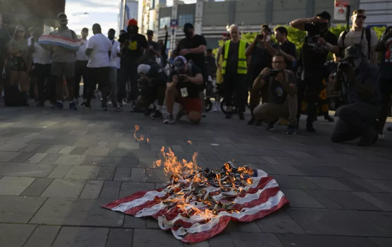 The American Flag is set on fire as demonstrators gather to protest the killing of Jayland Walker, shot by police, outside Barclays Center in New York, on July 6, 2022. - Jayland Walker, 25, was shot and killed June 27, after officers tried to stop his car over a traffic violation, the police department in the city of Akron said.
After initially providing few details of the shooting, Akron authorities released two videos: one that was a compilation of body-camera footage, body-cam still frames and voiceover, and another of the complete body-cam footage of the entire chase and shooting. (Photo by ANGELA WEISS / AFP)