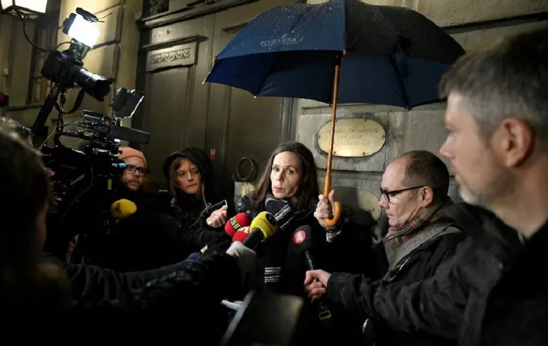The permanent secretary of the Swedish Academy, Sara Danius, reads the Academy's press release after a meeting on November 23, 2017 outside the Stock Exchange Building (Börshuset), which houses the Swedish Academy, in Stockholm's old city.



The Swedish Academy, which awards the Nobel Literature Prize, has been rattled by a sexual scandal as several Academy members, their wives and their daughters have claimed to have been assaulted by a well-known arts figure close to the prestigious institution.  / AFP PHOTO / TT News Agency / Vilhelm STOKSTAD / Sweden OUT