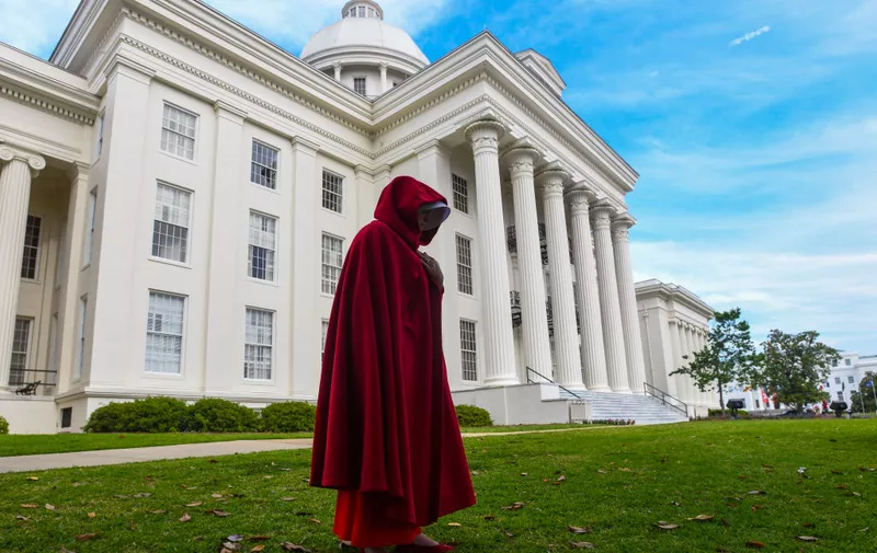 MONTGOMERY, AL - MAY 19: A protestor dressed as a character from the Hulu TV show "The Handmaid's Tale," based on the best-selling novel by Margaret Atwood, walks back to her car after participating in a rally against one of the nation's most restrictive bans on abortions on May 19, 2019 in Montgomery, Alabama. Demonstrators gathered to protest HB 314, a bill passed by the Alabama Legislature last week making almost all abortion procedures illegal.  (Photo by Julie Bennett/Getty Images)