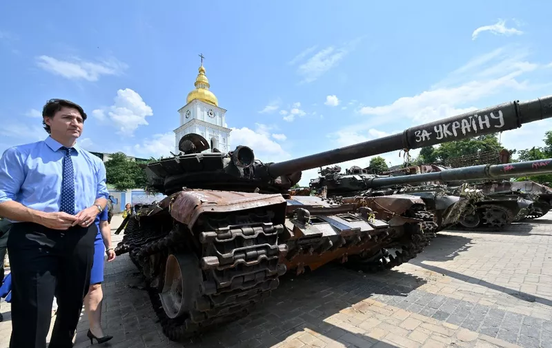 Canadian Prime Minister Justin Trudeau (L) visits an exhibition of destroyed military vehicles at Saint Michael's Square in Kyiv on June 10, 2023, amid Russia's invasion of Ukraine. (Photo by Sergei SUPINSKY / AFP)