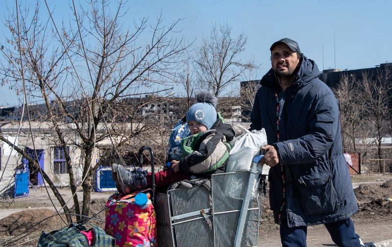 A man pushes his family and some of their possessions towards a checkpoint manned by Donetsk People's Republic forces on a road leading northwards away from the beseiged port city on the Azov coast.
Credit: Maximilian Clarke / Story Picture Agency
War in Mariupol, Ukraine - 21 Mar 2022,Image: 672286994, License: Rights-managed, Restrictions: , Model Release: no, Credit line: Profimedia