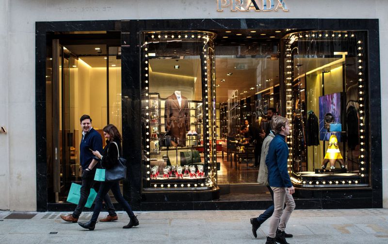 LONDON, ENGLAND - DECEMBER 20: Shoppers walk past a Prada store on Old Bond Street on December 20, 2018 in London, England. Figures released by the Office of National Statistics today show that retail sales in November increased by 1.4% despite gloomy predictions. This increase from October is attributed to Black Friday Sales encouraging higher sales of non-food items.  (Photo by Jack Taylor/Getty Images)