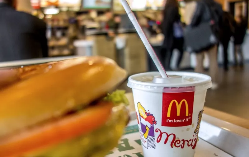 A container with a drink is served at the McDonald's fast-food outlet on February 26, 2015 in Lille, northern France. Several labour unions and a charity have formally accused McDonald's of cheating the French tax payer of hundred of millions of dollars by siphoning off European earnings through a Luxembourg unit over a five-year period since 2009. AFP PHOTO PHILIPPE HUGUEN
