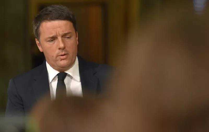 (FILES) This file photo taken on December 05, 2016 shows Italy's Prime Minister Matteo Renzi arriving for a press conference at the Palazzo Chigi following the results of the vote for a referendum on constitutional reforms, on December 4, 2016 in Rome. Renzi announced he would resign at 1800 GMT on December 7, 2016, three days after suffering a stinging defeat in a referendum on constitutional change. / AFP PHOTO / Andreas SOLARO